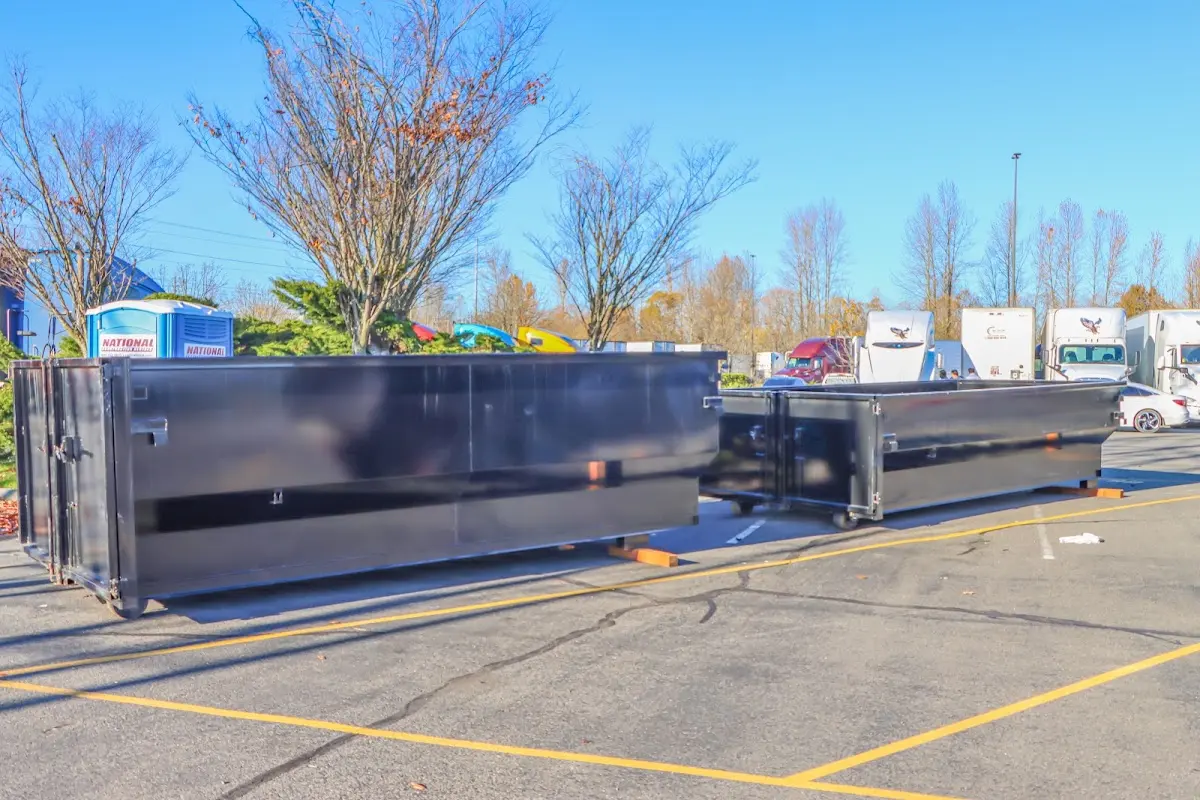 Professional dumpster rental service with roll-off container on residential driveway in Bloomingdale